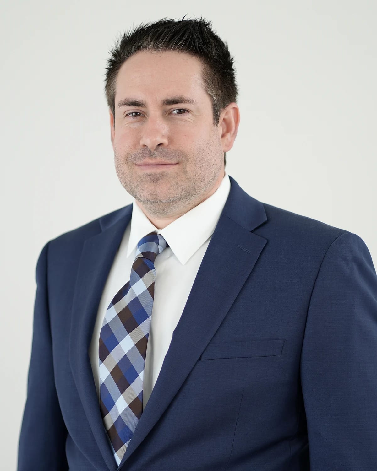 Dr. Justin Schwarting, DNP, PMHNP-BC, in a navy suit