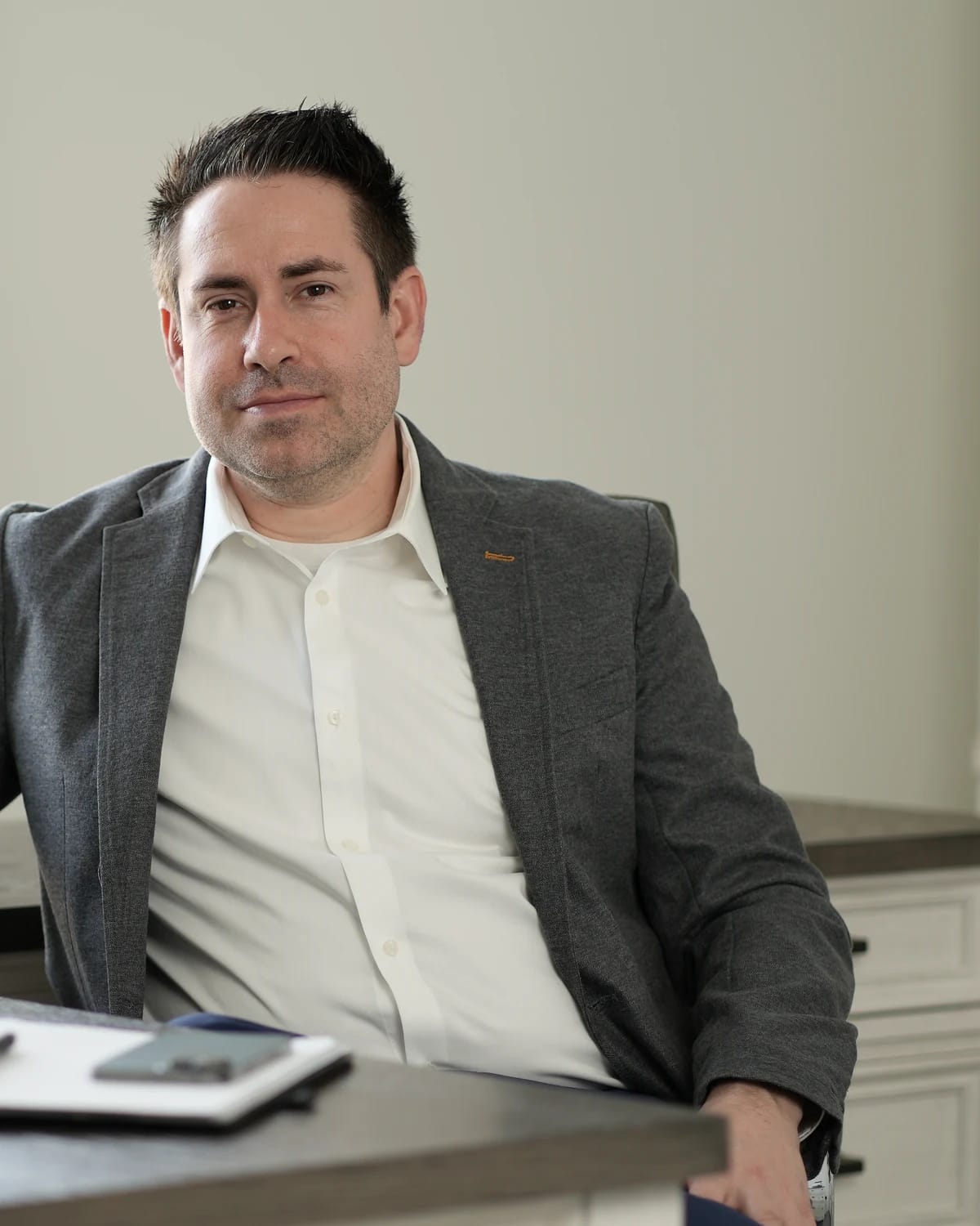 Dr. Justin Schwarting seated at his desk in his office